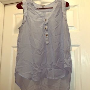 Pale blue tank top blouse with silver buttons.